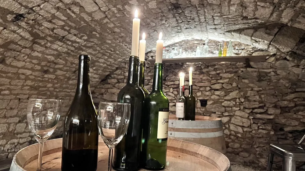 Wine glasses and bottles in the vaulted stone cellar