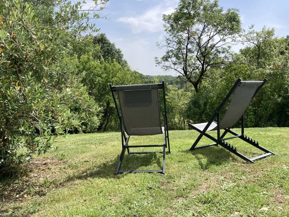 Deckchairs in the garden, under the trees