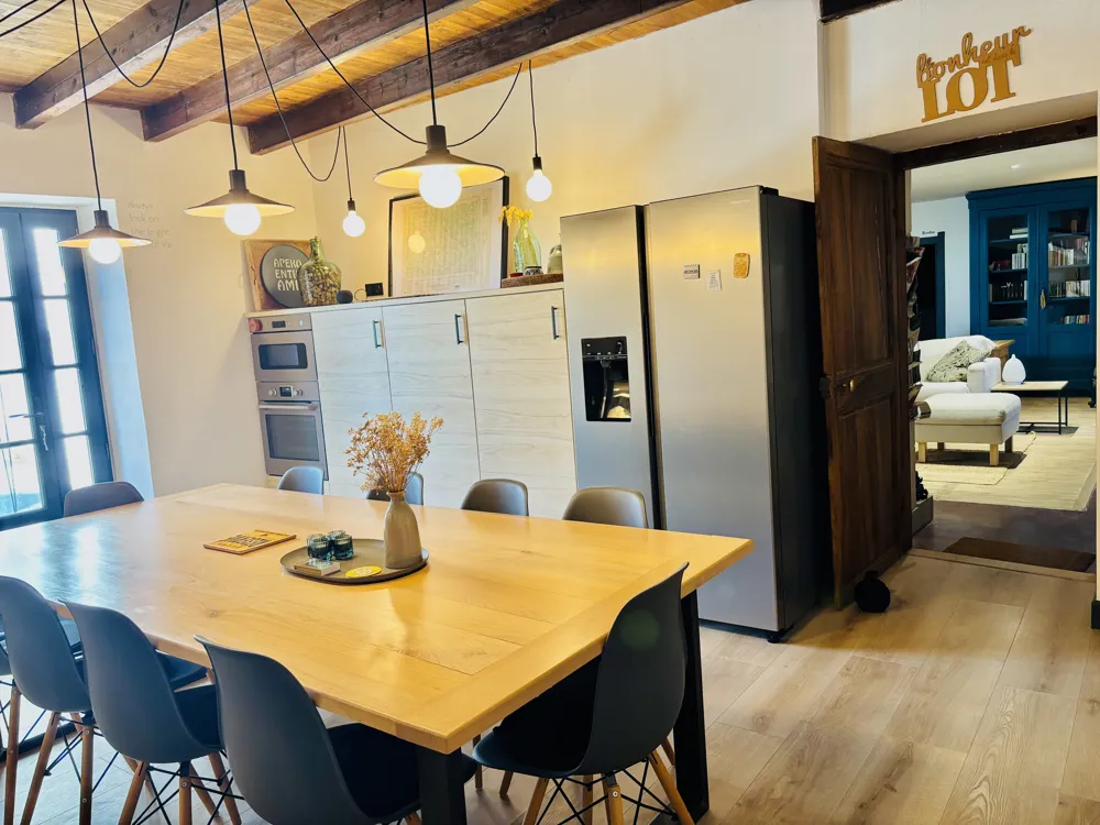 Kitchen with a large oak table and American fridge