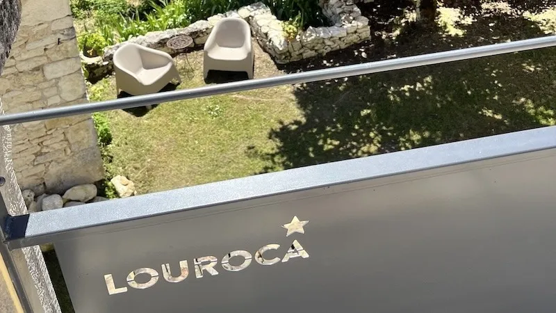 Louroca sign on the upper terrace and garden chairs