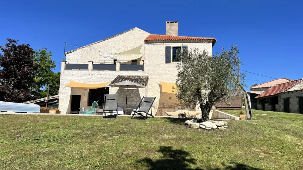 Stone facade of Louroca with its olive tree, Quercy Blanc