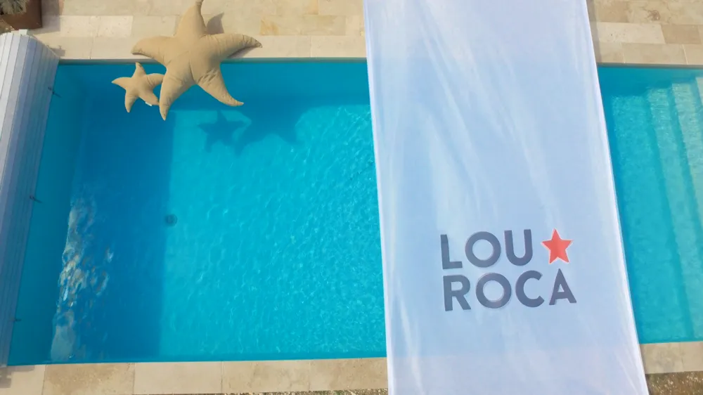 Saltwater pool with starfish and Louroca banner