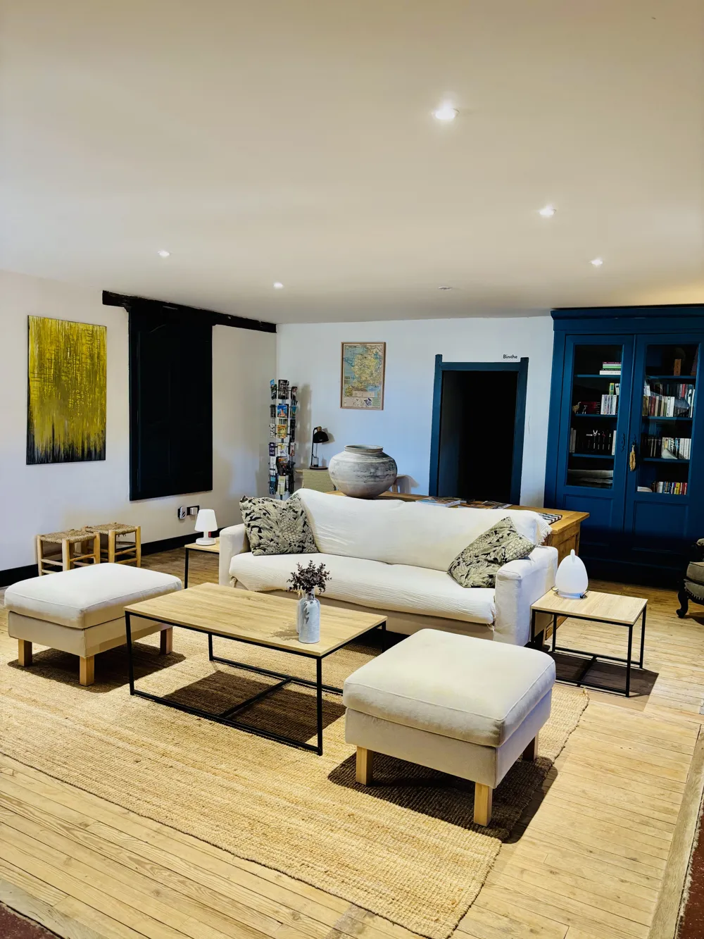 Living room with sofa, pouffe and rug