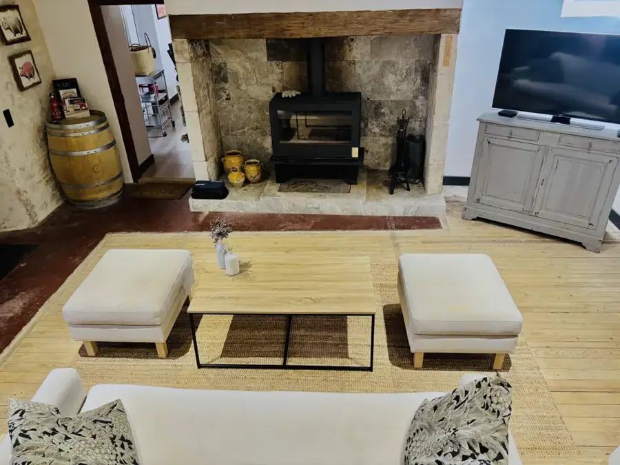 Living room with wood stove in the stone fireplace