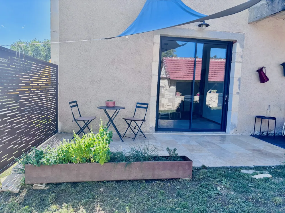 Terrace in front of the glass door with a steel planter